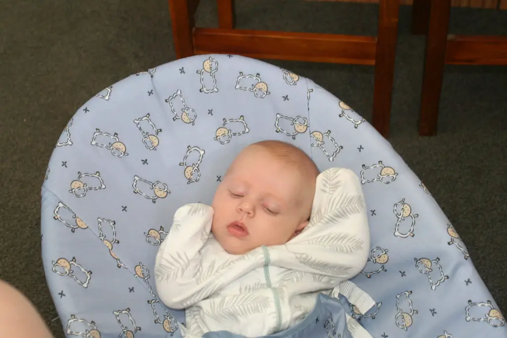 newborn sleeping in bouncer