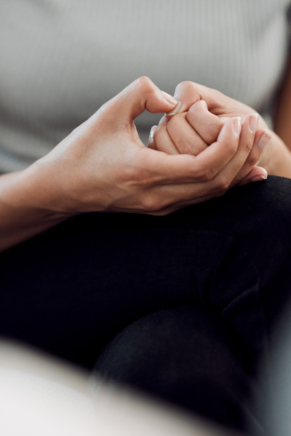 dealing with anxiety as a mum image of women holding her hands together